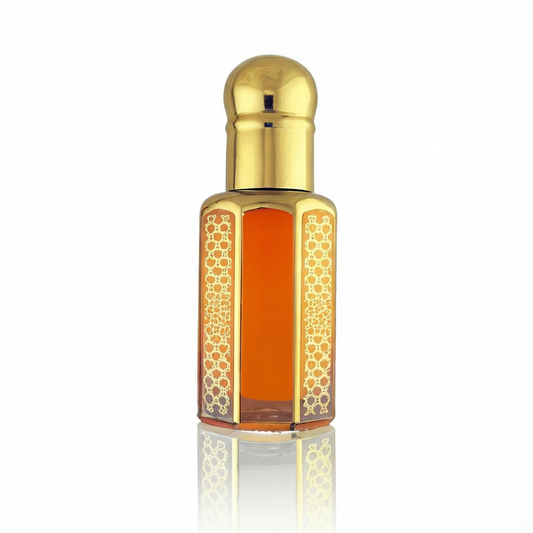 Shamamatul Amber perfume oil in a gold bottle on a white background, highlighting its warm amber oil color.
