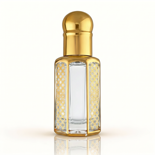 OudSpot Aventus-inspired fragrance oil in an ornate clear glass attar bottle with polished gold detailing.