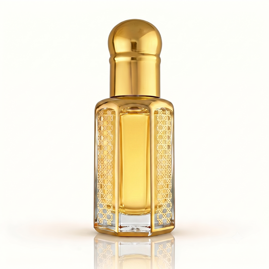 Ornate gold hexagonal glass bottle of Black Opium inspired fragrance oil isolated on a clean white background with a subtle reflection.